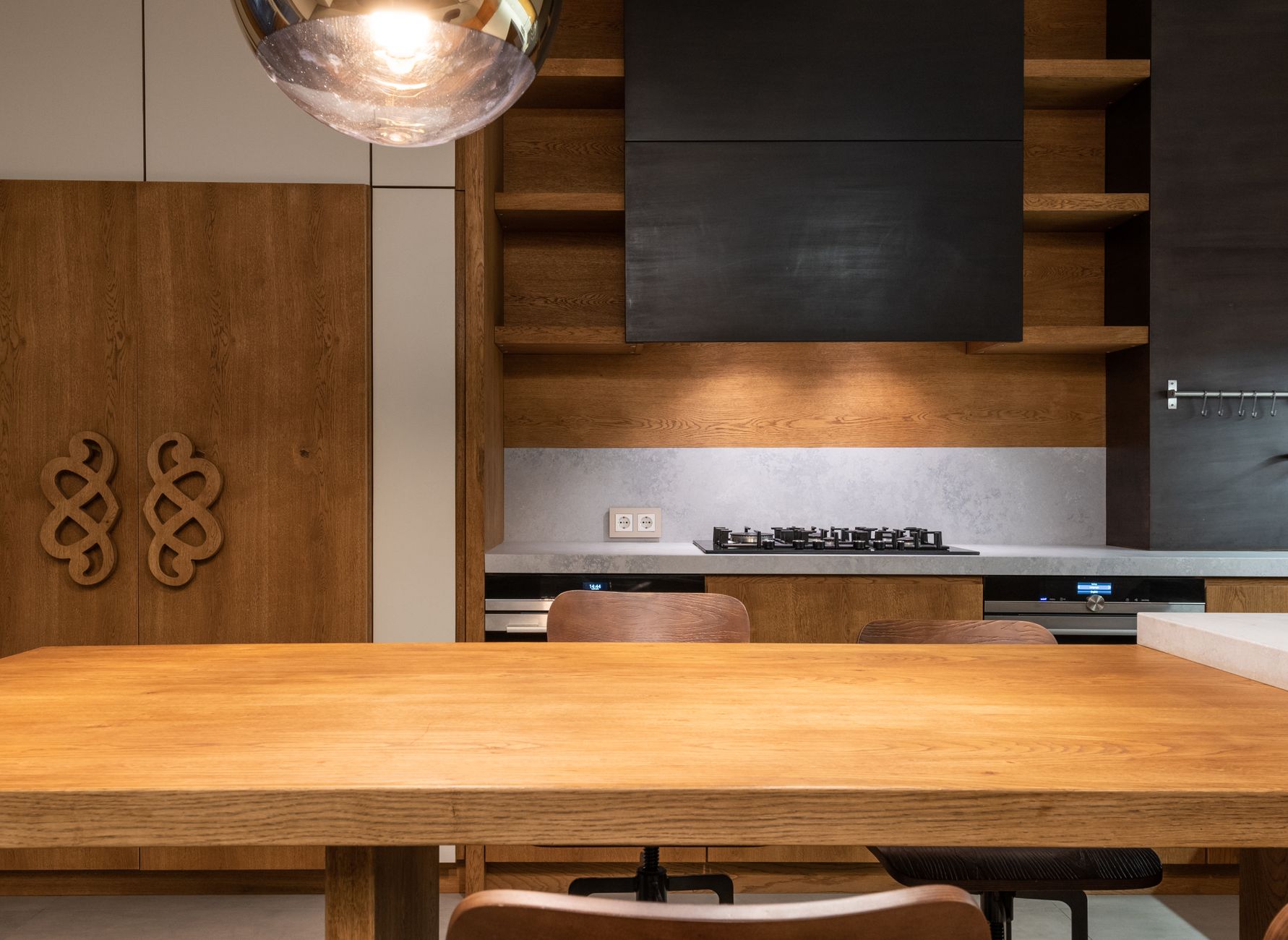 Stylish kitchen with wooden furniture, gas stove, and minimalistic decor in Austin, TX